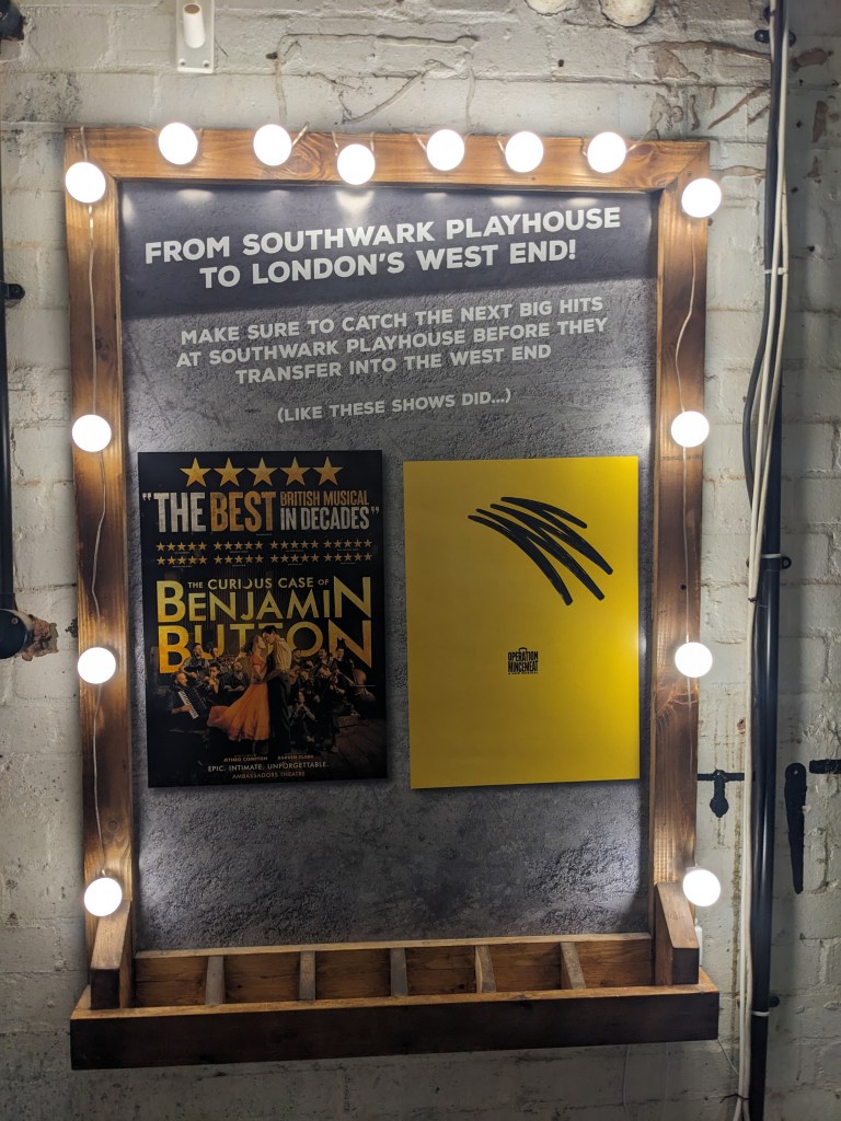 A poster at Southwark Playhouse showing past successes Benjamin Button and Operation Mincemeat